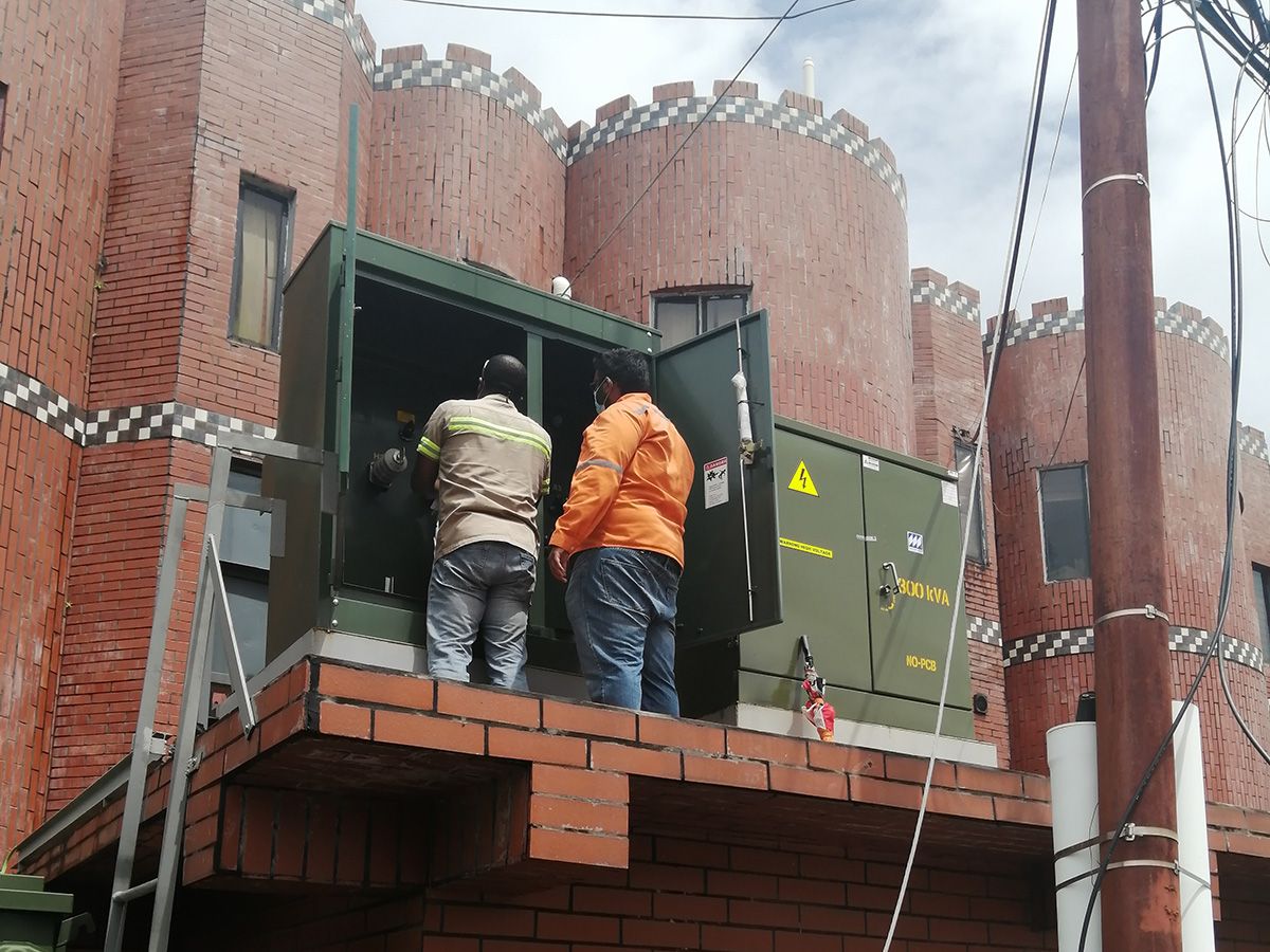 Technicians working in a pad mount transformer kiosk