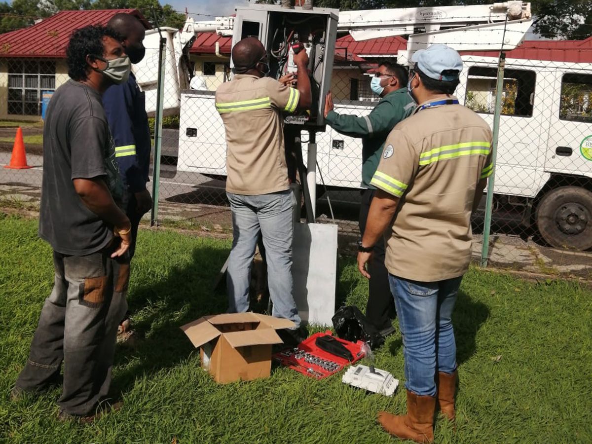 BELEC crew at an outdoor service pedestal with a service truck