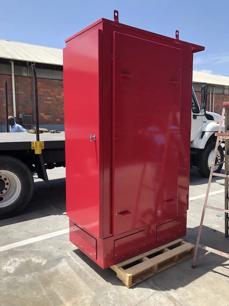Red powder-coated freestanding enclosure with drip hood