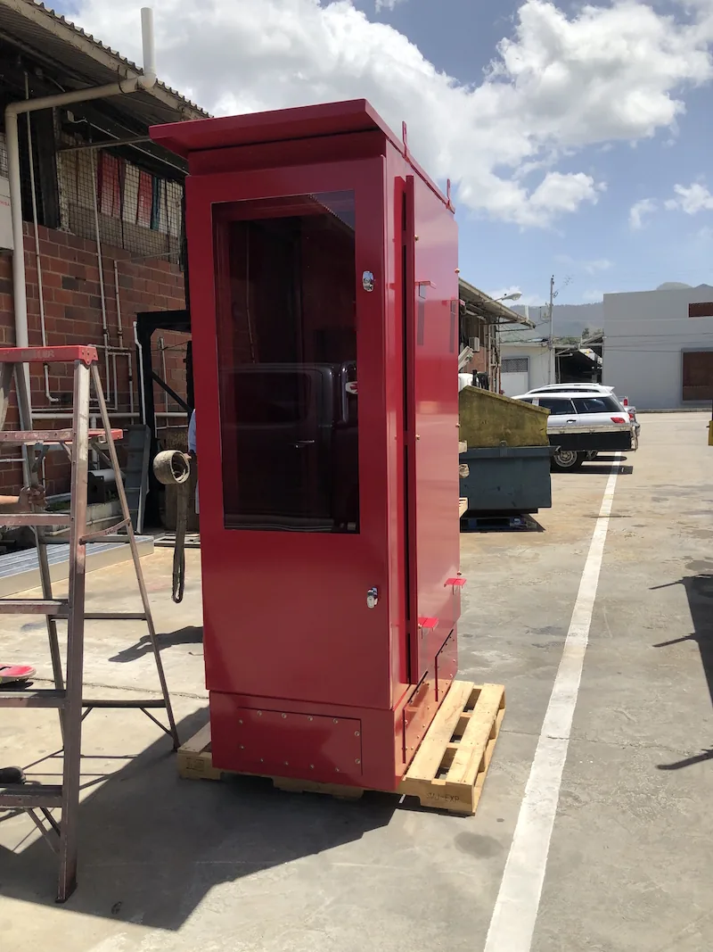 Red powder-coated enclosure with a glazed door, fabricated by EMF