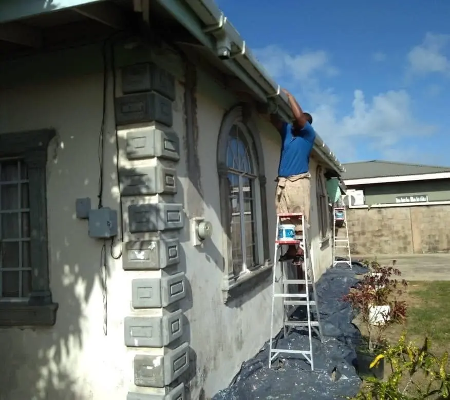 K R Nathaniel crew painting a house exterior