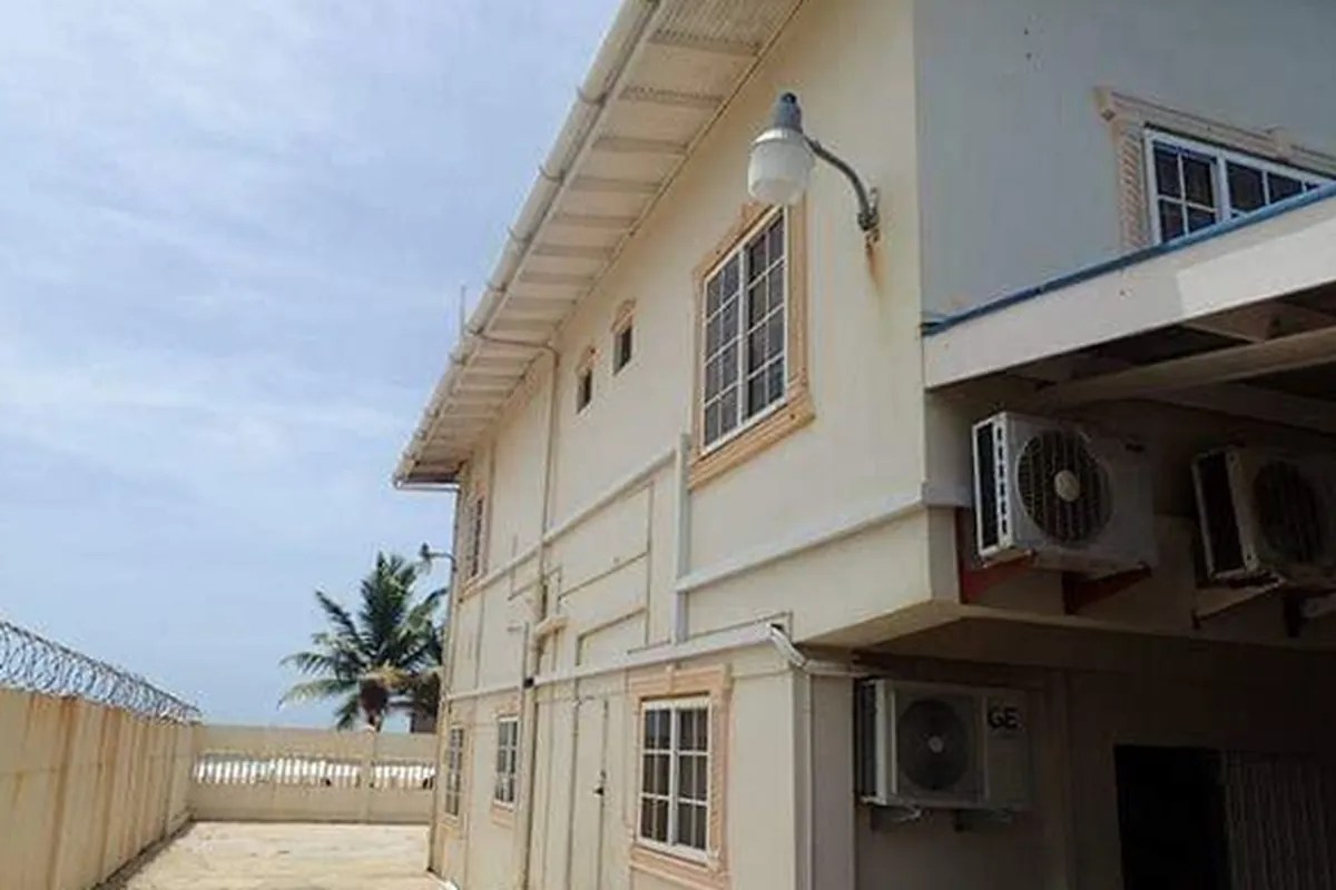 Before: Two-storey seafront house in faded cream