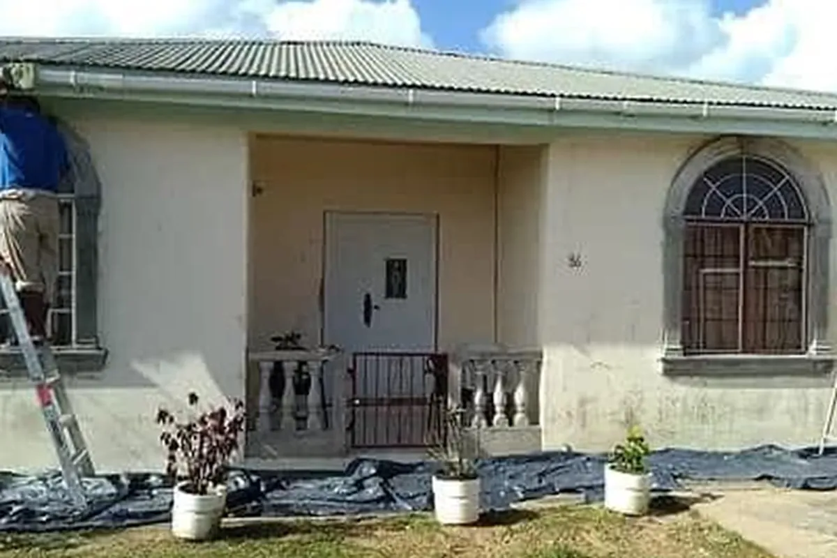 Before: Crew prepping the front of a bungalow