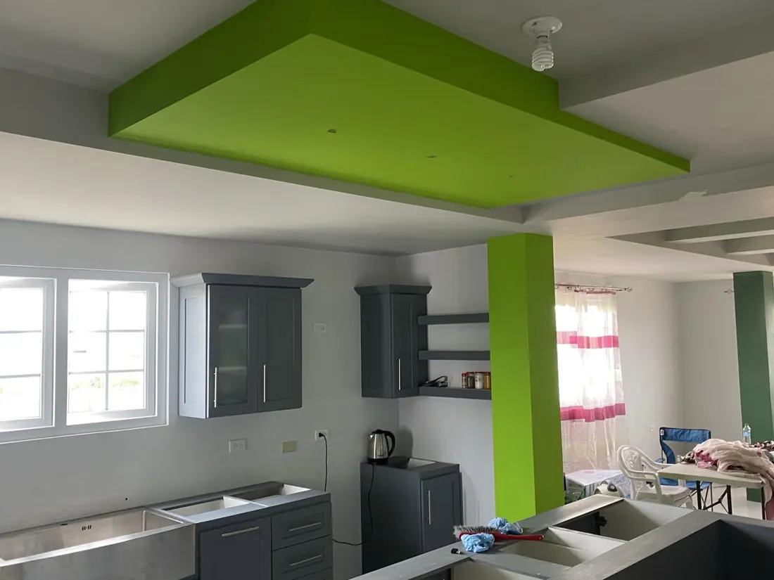 Kitchen with lime green ceiling drop and pillar