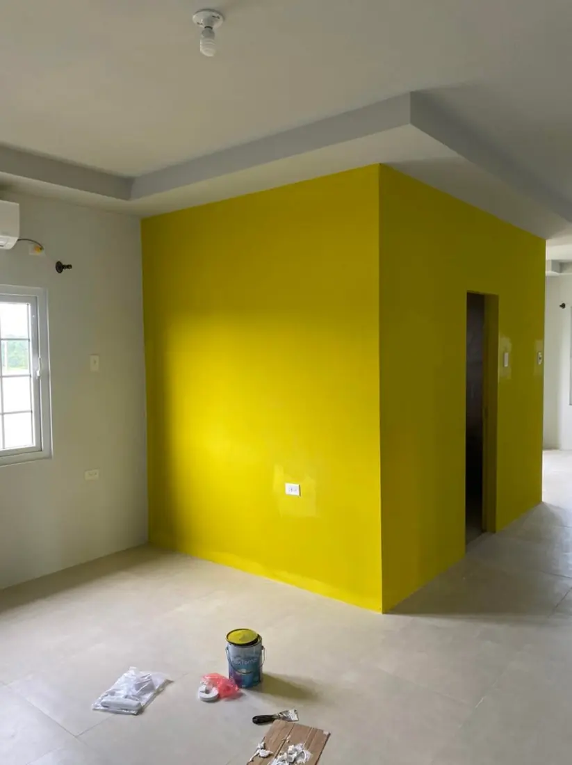 Yellow feature walls in an open-plan room