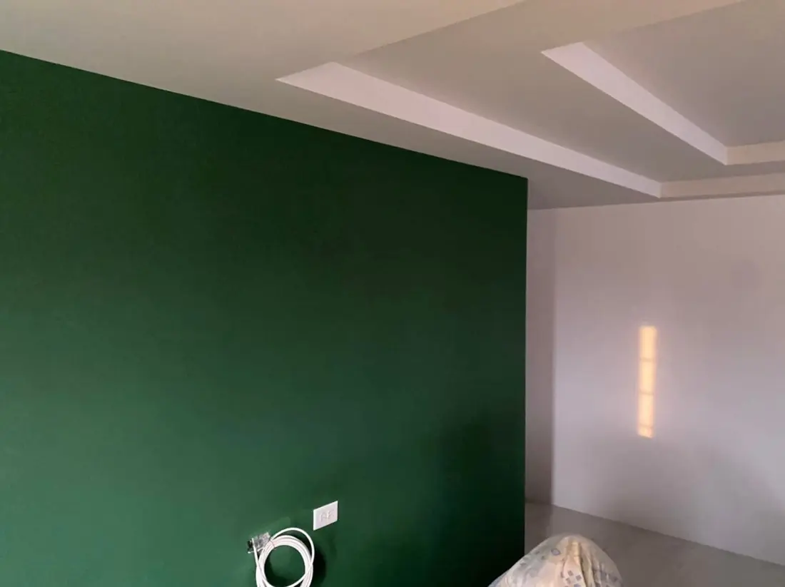 Deep green bedroom feature wall
