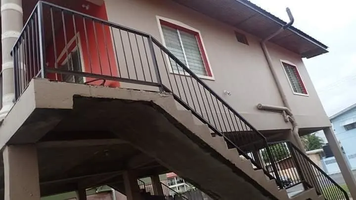 Dark brown stair railings on a raised house