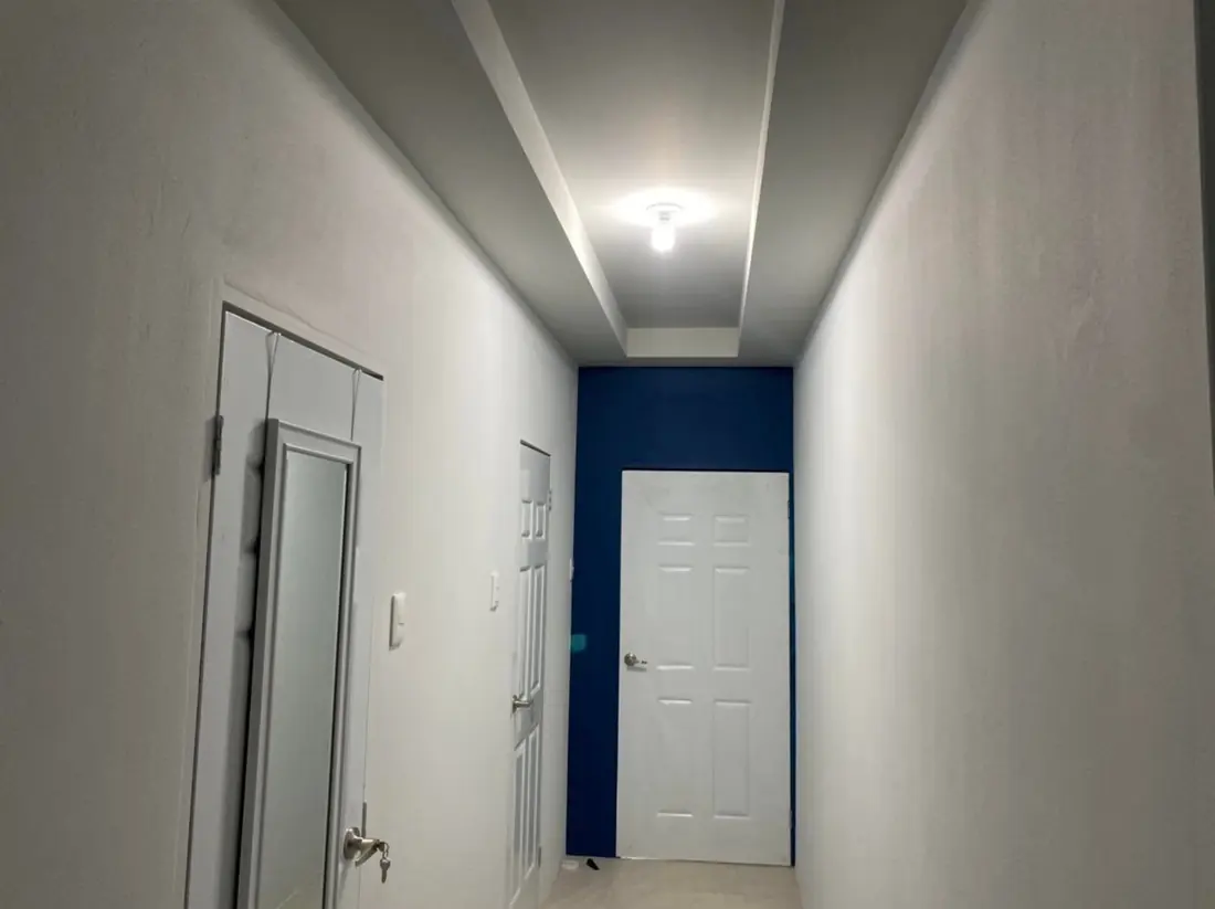 Grey corridor with a navy end wall