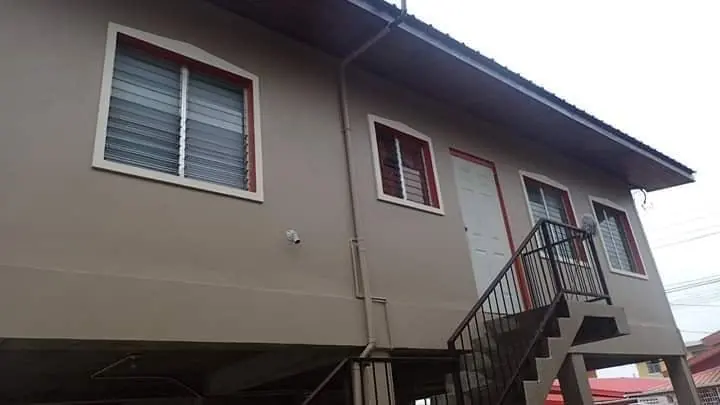 Raised house in taupe with an outdoor staircase